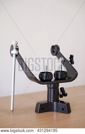 Yoke Altazimuth Mount, Thumb Screw, And Vertical Fine Adjustment Rod. Telescope Parts On Wooden Tabl