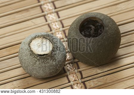 Pu'er Tea In Tangerine On A Bamboo Background, Close Up