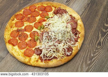 View From Above Peperoni And Calabrian Pizza, On Wooden Table.