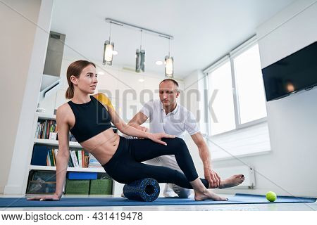Handsome Caucasian Reflexologist In White Shirt Working With Happy Cheerful Lady In Rehabilitation C