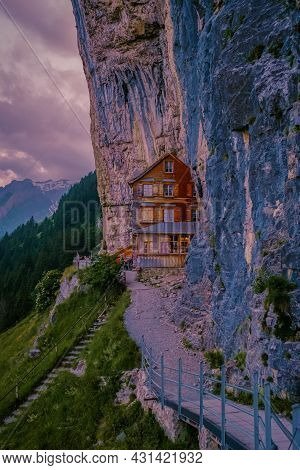 Swiss Alps And A Mountain Restaurant Under The Aescher Cliff Viewed From Mountain Ebenalp In The App