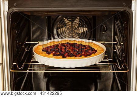 Closeup Homemade Gallet With Raspberries, Blackberry And Grapes Baked In A Home Oven. Shallow Focus.
