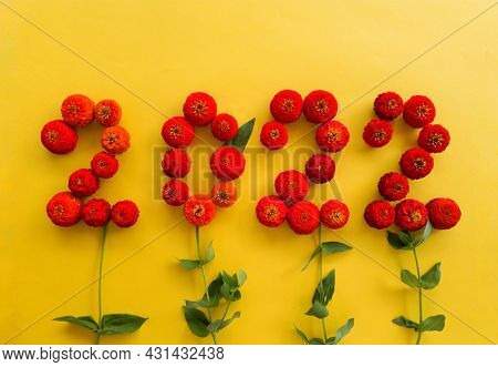 On A Yellow Background Of Red Flowers Of Tsinia, 2022 Is Laid Out