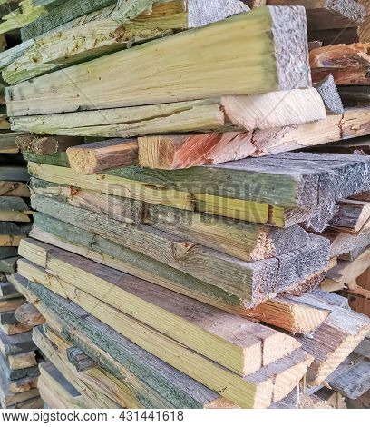 Background Of Cut Boards Stacked With A Cut Cut Forward. Preparation Of Firewood For Open Fire
