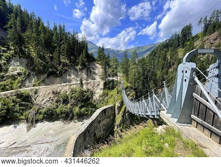 Suspension Bridge Over Dam In The Austrian Mountains