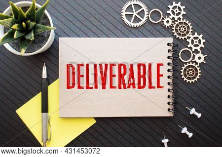 Modern Business Buzzword - Deliverable. Top View On Keyboard And Puzzle With Wooden Blocks. Close Up