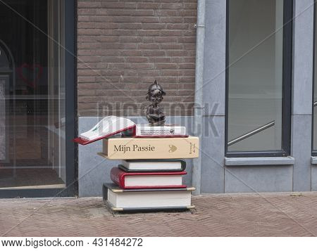 Hulst, Netherlands, August 29, 2021, Large Giant Book Marked My Passion And A Helmeted Doll Reading 