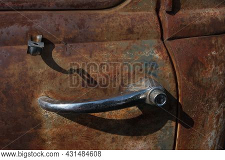 Close-up Of A Chrome Door Handle Of An Old Rusty Car