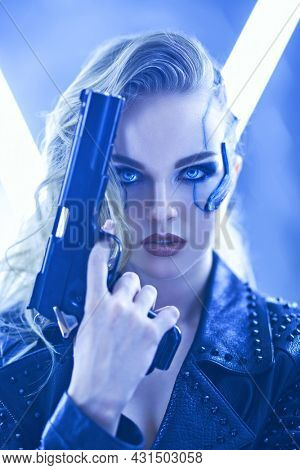 Sci-fi cyborg soldier girl. An attractive girl cyberpunk stands on alert with a gun among the neon lights. World of the future. Game, virtual reality.
