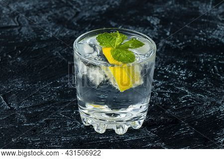 Serving Mojito In Glass. Drink With Lemon, Mint, Soda And Ice On A Black And White Background. Soft 