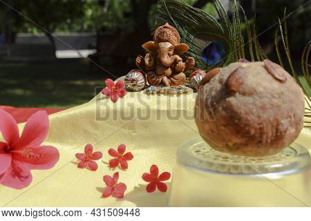 Beautiful Lord Ganesha Idol Worshipped During Ganesh Chaturthi Festival With Peacock Feather In Back