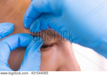 Man With Pierced Eyebrow. Three Small Black Piercings.