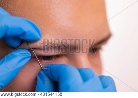 Man With Pierced Eyebrow. Three Small Black Piercings.
