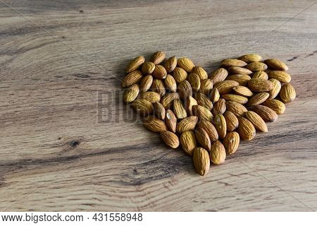 Almonds Lying On The Table In The Form Of A Heart. Copy Space