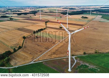 Windmill Among Agricultural Fields. Wind Turbine Generator At Summer Day. Wind Energy Concept, Suist