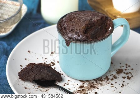 Mugcake Is Microwaved. Homemade Cupcake In A Mug Is On A Plate.