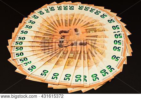 Pile Of 50 Real Euro Banknotes Isolated On A Black Background.