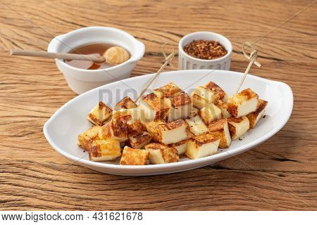Grilled Rennet Or Coalho Cheese With Sugar Syrup And Pepper On A Wooden Table.