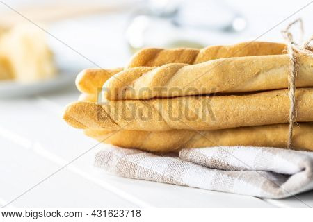 Grissini sticks. Traditional italian bread sticks on white table.