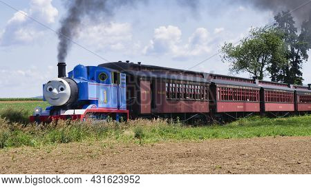 Ronks, Pennsylvania, June 2019 - Thomas The Tank Engine Approaching Pulling Passenger Cars Blowing S