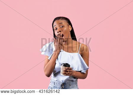 Tired African American Woman Holding Papercup With Takeaway Coffee And Yawning On Pink Studio Backgr