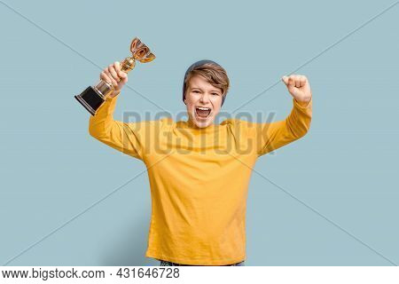 A Teen Boy Winner Holding A Trophy