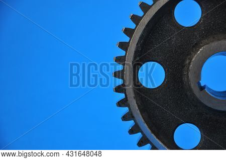 Metal Cogwheel On A Blue Background. Spare Parts,