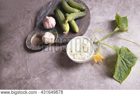 Top View Of A Bowl With A Traditional Greek Tzatziki Sauce Made Of Cucumbers, Yogurt And Garlic. Med