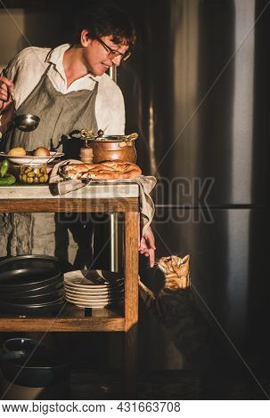 Woman Cooking Turkish Traditional Meat Soup Haslama And Touching Cat