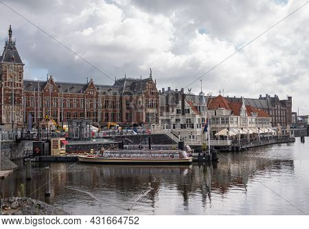 Amsterdam, Netherlands - August 14, 2021: East Side Of Red Stone Central Railway Station Under Heavy