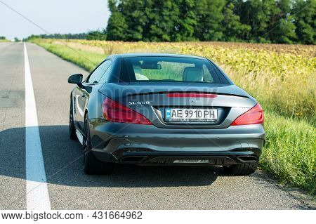 Dnepropetrovsk, Ukraine - 08.24. 2021: Photos Of The Mercedes Benz Sl550 Convertible On The Road.