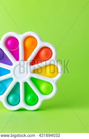 Presses With A Finger Anti-stress Toy Pop It On Green Background. Colorful Silicone Poppit Toy, Bubb