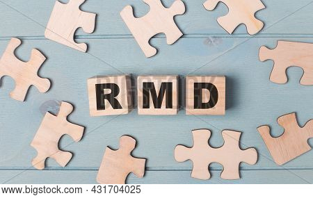 Blank Puzzles And Wooden Cubes With The Text Rmd Required Minimum Distributions Lie On A Light Blue 