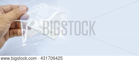 Own Hand Showing Covid-19 Positive Test Result With Sars Cov-2 Rapid Antigen Test Kit (atk) In The Z