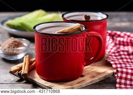 Traditional Mexican Chocolate Atole Drink On Wooden Table