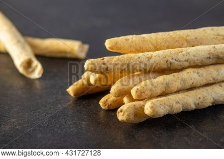 Grissini sticks. Traditional italian bread sticks on black table.