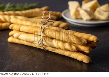 Grissini sticks. Traditional italian bread sticks on black table.