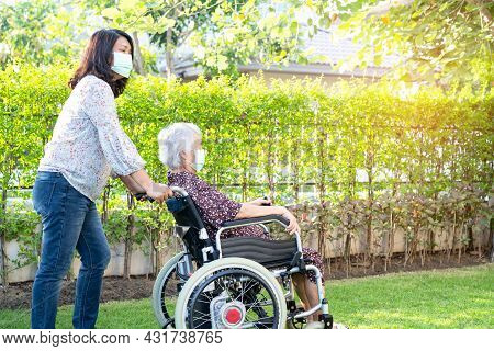 Doctor Help And Care Asian Senior Or Elderly Old Lady Woman Patient Sitting On Wheelchair At Park In