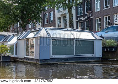 Amsterdam, Netherlands - August 15, 2021: Modern Styly Flat Gray House Built On Ponton Functioning A