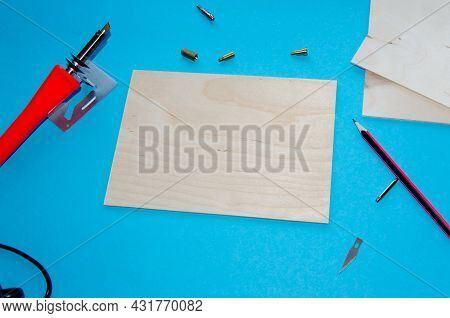 A Pyrography Tool On A Blue Background.selective Focus