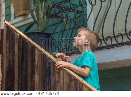 Copy Space Lifestyle Boy Move Climb Wood Stairs Up Outside Hold Handrails, Look For Up Facial Expres