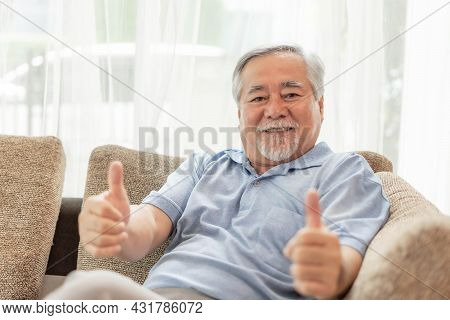 Portrait Asian Senior Man , Old Man Giving A Thumb Up Feel Happy Good Health On Couch Living Room In