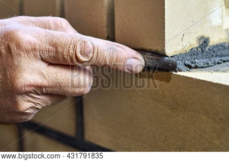 Bricklayer Builds New Fence From Facing Bricks. Alignment Of Inter-brick Joints