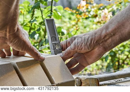 Bricklayer Levelling Bricks On The New Fence From Facing Bricks Using Building Level.