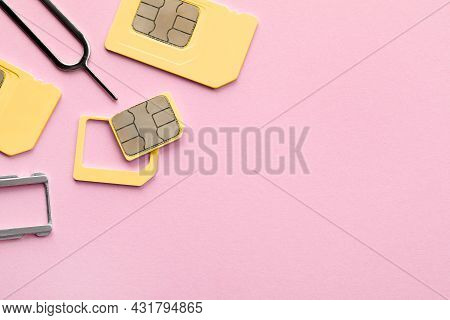 Sim Card, Tray And Ejector On Pink Background, Flat Lay. Space For Text