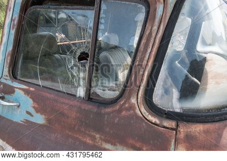 Partial View Of The Damaged Windows Of An Old Car