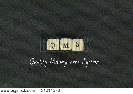 Small Wooden Cubes With The Letters Qms Or Quality Management System