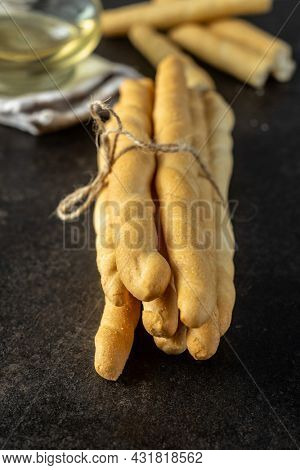 Grissini sticks. Traditional italian bread sticks on black table.