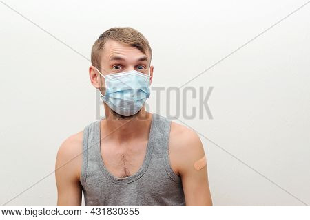 Happy Man Showing His Arm With Bandage After Receiving Vaccine. Vaccination, Immunization, Inoculati