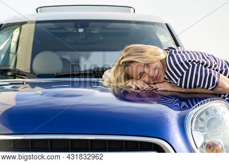 Middle Woman Driver Dreaming, Embracing Hood Of Car After Detailing, Polishing. Happy Female Custome